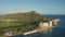 A drone view at sunset of Waikiki Beach and Diamond Head Crater, a famous tourist destination in Honolulu, Oahu, Hawaii