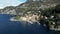 Drone view of town along lake Como with ship, boats and mountains