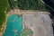 Drone view of the turquoise lake formed as a result of mining waste