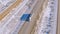 DRONE: White truck hauls cargo down scenic freeway running across snowy desert