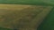 Drone wide shot haystack and harvesting dry grass, aerial hay bales at field