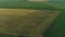 Drone wide shot haystack and harvesting dry grass, aerial hay bales at field