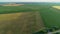 Drone wide shot haystack and harvesting dry grass, aerial hay bales at field