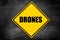 Drones written on caution sign