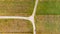 Drop down view of dirt road T-junction surrounded with fields.