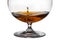 A drop falls in glass with cognac