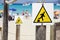 Drop warning sign , falling of the edge yellow triangle warning sign on the beach