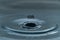 A drop of water hovering in the air before hitting a water surface, which will cause a beautiful splash, close-up photo