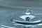 A drop of water hovering in the air before hitting a water surface, which will cause a beautiful splash, close-up photo