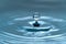 A drop of water hovering in the air before hitting a water surface, which will cause a beautiful splash, close-up photo