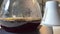 Droplets of brewed coffee drip slowly into the coffee pot mounted on the platform of a black coffee maker Morning. Slow