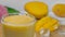 Droplets falling in a transparent glass of refreshing mango milkshake / juice - Summer drink India