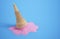 Dropped ice cream. Pink melted ice cream on blue surface. 3D illustration
