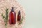 Dropper bottle of essential oil or serum, eucalyptus and dark dispenser bottle of shower gel. SPA concept.