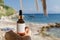 Dropper bottle presentation against beach backdrop. Cosmetic mockup