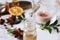 Dropping anise essential oil from pipette into bottle on table, closeup