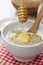 Dropping honey by wooden dipper on Scottish porridge