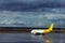 Drops of rain flow down the glass at the airport. Airport in rainy autumn weather. Lone DHL Express aircraft.