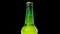 Drops trickle down the beer bottle. Cold and fresh beer bottle on black background