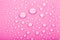 Drops of water on a color background. Pink. Shallow depth of fie