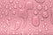Drops of water on a color background. Pink. Shallow depth of fie
