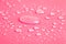 Drops of water on a color background. Toned pink. Shallow depth