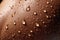 Drops of water on a woman\\\'s tanned skin. Background.