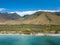 Drove side view of the dry mountains and crystal clear waters of the Lahaina Coast on the island of Maui, Hawaii