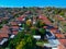 Drown view looking down on sydney residential houses in Sydney suburbia suburban house roof tops and streets NSW Australia