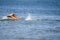 Drowning woman\'s legs sticking out of sea