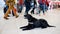 Drug detection black dog resting at the airport on the background of people.Horizontal view