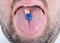 Drug pill on the man\'s tongue