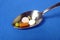 Drugs on spoon, blue textured background