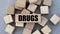 DRUGS - words on wooden bars on cubes on a gray background