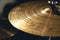 Drum cymbal close-up on a dark background.