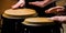 Drum. Hands of a musician playing on bongs. The musician plays the bongo. Close up of musician hand playing bongos drums