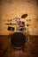 Drum set red painted in lacquer, on the background of the wall vintage style on the wooden floor,