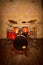 Drum set red painted in lacquer, on the background of the wall vintage style on the wooden floor