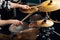 Drummer banging on a cymbal in a drum set.