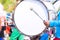 Drummer in blue uniforms a Marching Band. Drummer plays big drum in parade