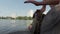 Drummer hands playing on a makeshift drum on a background of lake and building, drum sets, pulling ropes, lake, willow branches