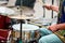 Drummer man playing drums percussion with drum sticks, drum set on concert stage, sticks and drums