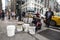 Drummer man playing from plastic pots like a drum on Seventh Avenue 7th Avenue while a man