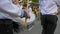 Drummer in marching band, young sailor with sticks in hands close-up plays on big drum during the parade in the street