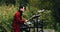 The drummer plays electronic drums in the forest. Behind him trees. Interesting plan.