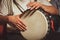 The drummer plays the ethnic percussion musical instrument djembe