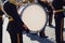 Drummer with white bass drum close up with  military brass orchestra on urban music festival