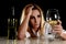 Drunk alcoholic blond woman alone in wasted depressed looking thoughtful to white wine glass