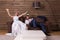 Drunk bride with bottle, groom sleeping on couch