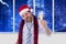 Drunk businessman drinking champagne wearing a santa hat in office